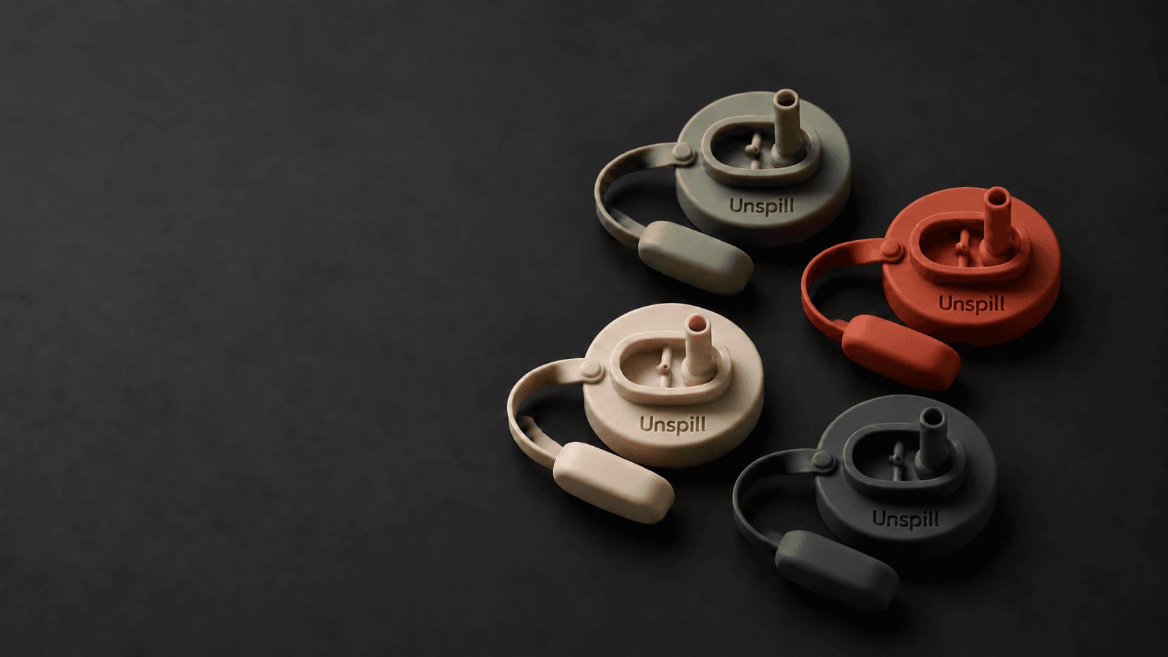 Four Unspill silicone can covers in Sage, Terracotta, Oat, and Charcoal